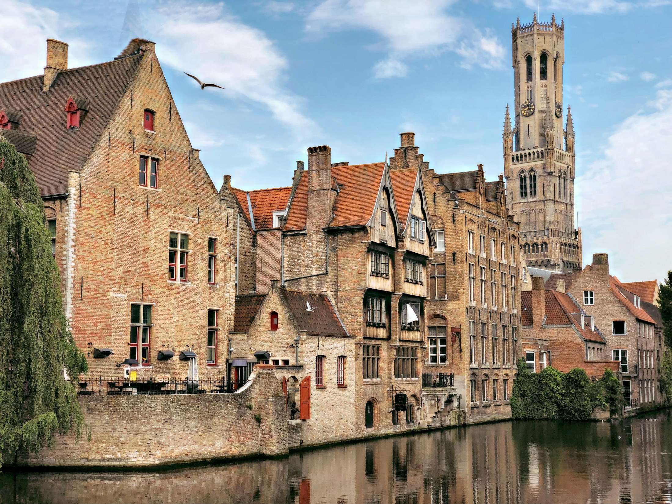 Historic brick houses reflected in a Bruges canal